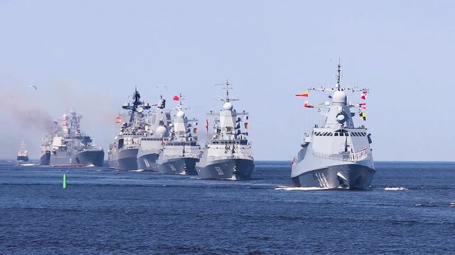 A line ahead of modern russian military naval battleships warships with submarine in the row, northern fleet and baltic sea fleet, summer sunny day, vibrant image