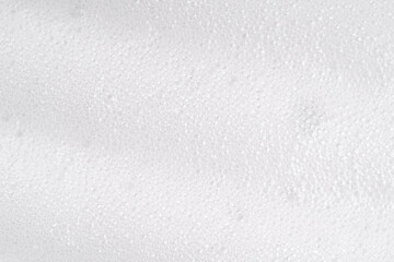 Obraz premium White foamy cleansing skin care product texture from soap, detergent, shampoo, shaving foam or cleanser. Soapy surface closeup. Foam macro background with bubbles. Beer drink backdrop, laundry spume