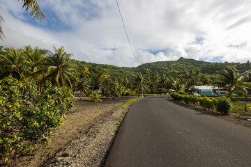 Small road on a tropical island surrounded by jungle
