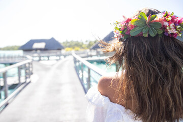 Naklejka premium Woman wearing colorful flower crown on vacation at beautiful tropical island Bora Bora in French Polynesia
