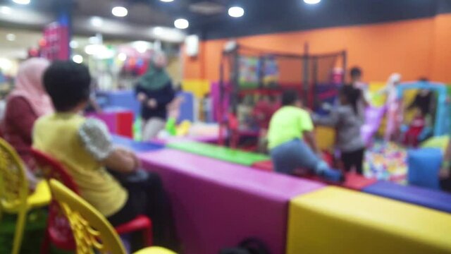 Blur Image of Indoor Playground for kids. Lots of kids enjoy and have fun playing together.