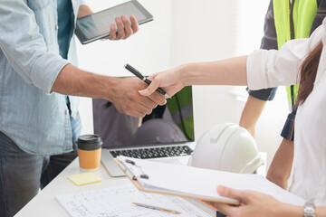 Close up hand of group, team young contractor, engineer handshake with partnership, customer after agreement to work together at the site, workplace, office. Business success concept.