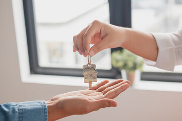 Close up hand of home, apartment agent, realtor was holding the key to the new landlord, tenant or...