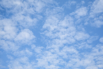 Blue sky with white clouds in daylight for background.