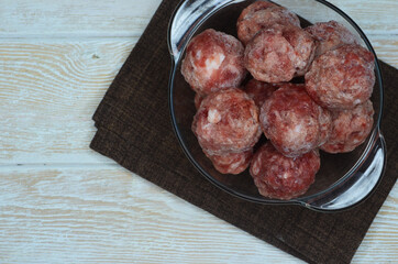 raw meat in balls, frozen minced meat, minced pork, semi-finished products for cooking at home, ingredients for cooking meat dishes