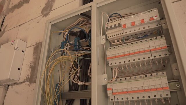 Modern Switch Control of Electric Board with Plastic Levers and Transmission Wires Connected to Boxes. Domestic Electrical Shield. Electrical switchboard, wire, automat.
