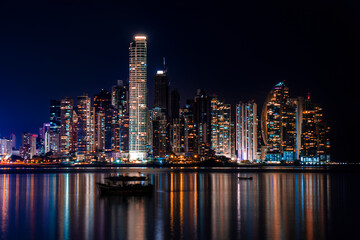 Panama City Skyline at Night with water reflecting the light  - obrazy, fototapety, plakaty
