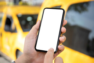 male hand holding phone with isolated screen yellow taxi cars