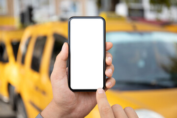 male hand holding phone with isolated screen yellow taxi cars