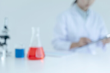 Blurred image of Scientists work in lab, Researcher conduct experiment analyzing drug treatment..