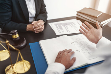 Lawyer with lawsuit meeting with client discussing with contract agreement at courtroom..