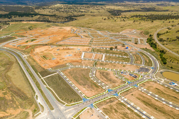 Aerial drone view of new road development and residential construction site in the newly...