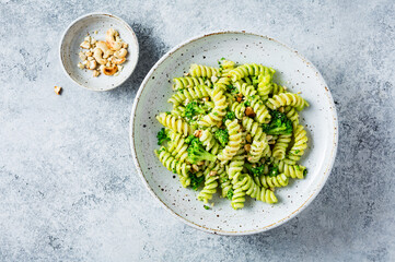 Vegetarian green pasta with broccoli and cashew nuts. Vegetarian healthy food. Top view. copy space