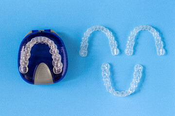 Invisalign braces or invisible retainer on blue background