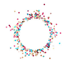 A round frame made of multicolored shiny metallized confetti is on a white background. Festive layout. Flat lay. Top view. Copy space.
