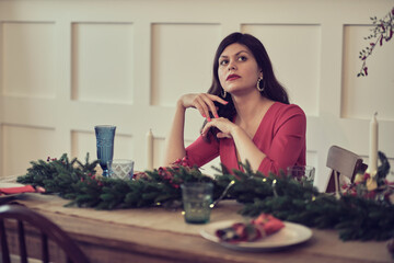 Sad pensive mature woman sitting at dining table and celebrating birthday alone at home. frustration, happiness, holidays concept
