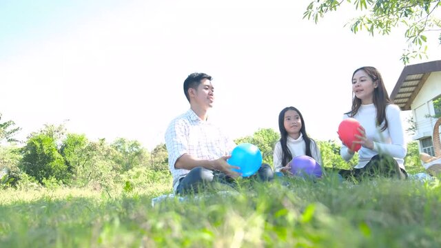 Asian portrait family trip father mother and daughter enjoy relaxation playing balloons with family to lifestyle freedom family vacation caucasian asian.one day trip new normol Coronavirus covid 19