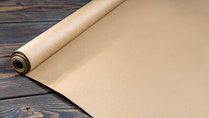 roll of craft paper on wooden background.