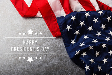 United States National Holidays. American or USA Flag with "HAPPY PRESIDENT'S DAY" text on cement background, President Day concept