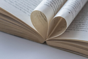 A book page with a heart shape on an open book. Valentine's Day. Love.