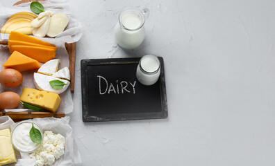 Different fresh dairy products on gray background.