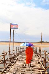 Buddhist monk on bamboo bridge across Mekong, Kampong Cham, Cambodia