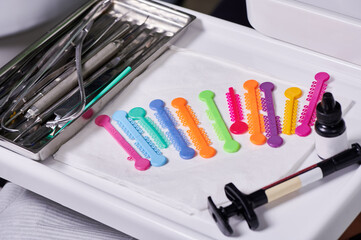 Top view on orthodontic elastomeric rings in orthodontic treatment. A set of multi-colored rubber...