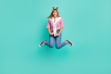 Full size photo of young lovely pretty smiling cheerful girl with sweater on shoulders jumping...