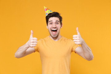 Young smiling caucasian cute gladden satisfied excited man 20s in basic t-shirt wearing birthday...