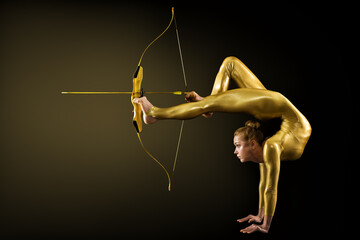 Archer Shooting by Legs with Gold Bow and Arrow. Flexible Gymnast aiming Target standing on Hand...