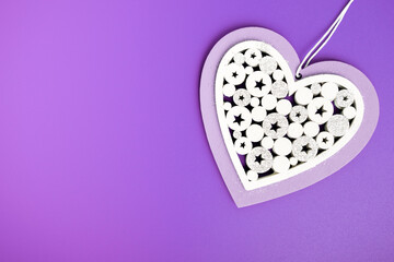 Happy Valentine's Day on February 14, white Heart on a lilac background with k copy space