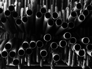 stack of steel pipes in black and white