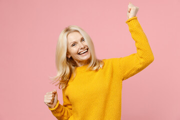 Happy cheerful elderly gray-haired blonde woman lady 40s 50s years old in yellow casual sweater...
