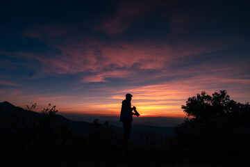 A photographer taking a picture after the sunset