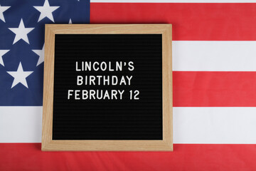 Fototapeta na wymiar black letter board with text Lincoln's Birthday and American flag . top view flat lay copy space 