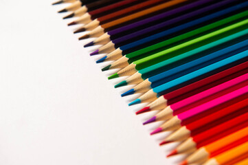 Colored pencils lie on a white background.  A set of colored pencils. Bright colors.
