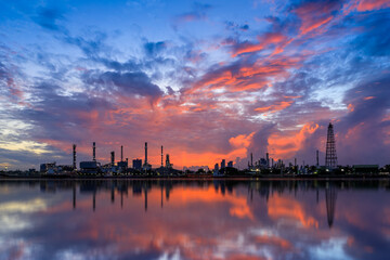 Oil and gas refinery plant factory with refection on river at twilight. petrochemical and energy industry concept.