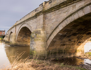 Old stone arched bridge over a river