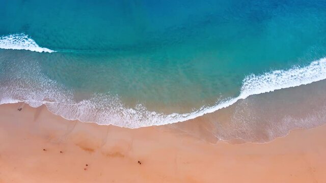 Aerial view of drone. Scene of top view beach and seawater on sandy beach in summer. Nature and travel concept.