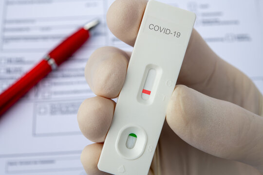 Covid-19 hand in glove and blood test tube