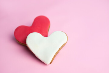 Two heart shaped cookies on  pink   background with   copy space. Valentines day greeting card .