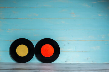 Two vinyl records on wooden background,vintage style