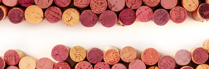 Obraz na płótnie Canvas Wine corks panorama, a design template for a restaurant menu or tasting invitation, top shot with a place for text, on a white background