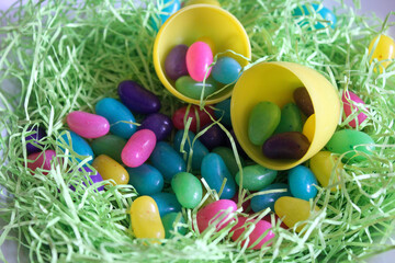 Fototapeta na wymiar Jelly beans and egg in Easter grass.