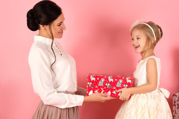happy mom and daughter with gift box