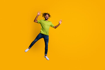 Fototapeta na wymiar Photo portrait full body view of man jumping up next to blank space isolated on vivid yellow colored background