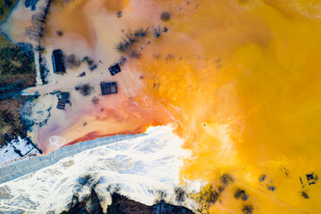 Aerial drone view of water pollution of a copper mine exploitation. Chemical residuals flooded natural environment, ecological bomb. Geamana, Rosia Montana, Romania