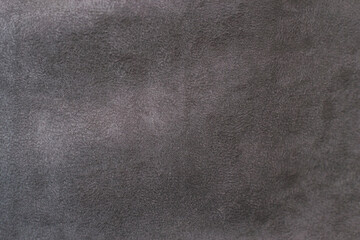 Fototapeta na wymiar Fabric is grey suede. The texture is faux suede . Background of a suede curtain.