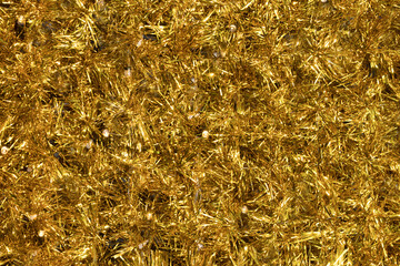 Close up gold tinsel Christmas background.