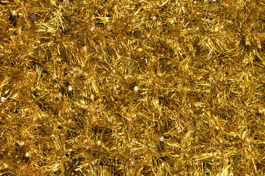 Close up gold tinsel Christmas background.